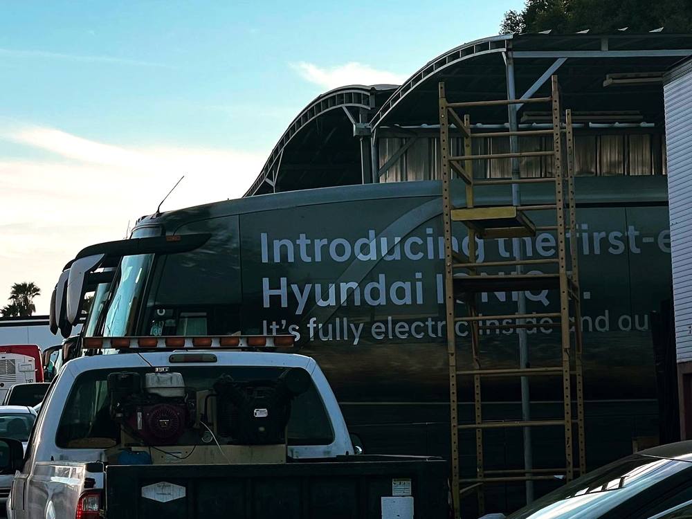 Motorcoach ad wrap install in progress